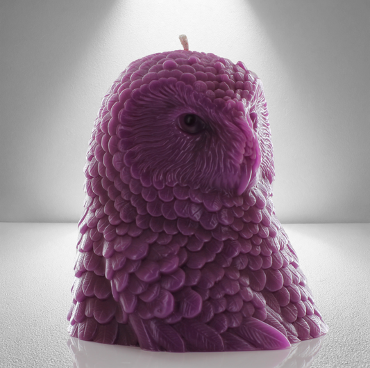 Lilac owl shaped candle with detailed feather design, set against a gray background