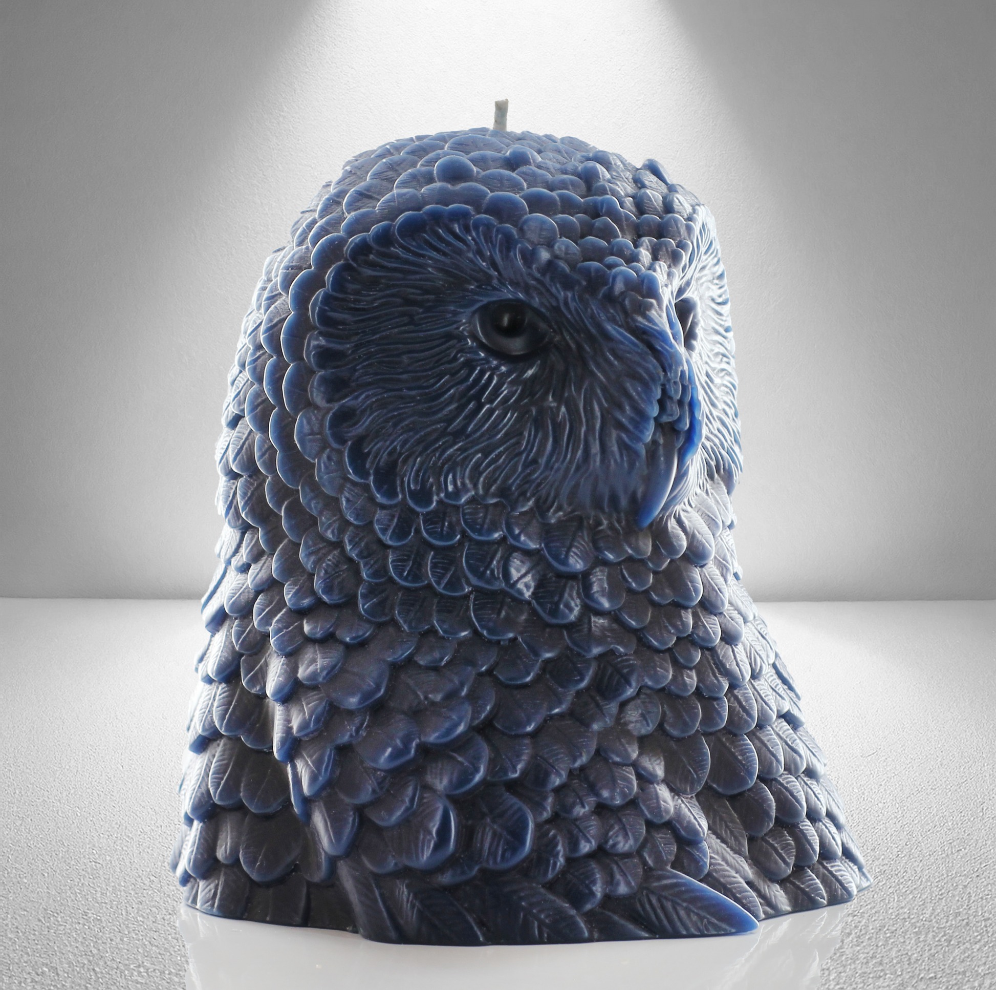 Navy Blue owl shaped candle with detailed feather design, set against a gray background