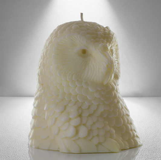 Soy unscented candle shaped like an owl, featuring intricate feather details and a bold, elegant design inspired by Athena