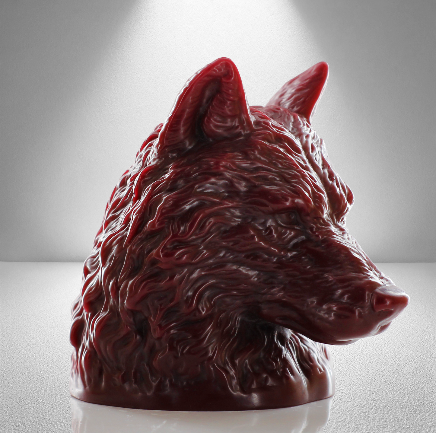 Large dark red unscented candle shaped like a wolf's head, featuring intricate fur details and a bold, majestic design.