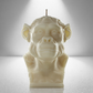 Front view of a soy unscented candle shaped like a chimpanzee, featuring detailed facial and fur textures. Bold and expressive design.