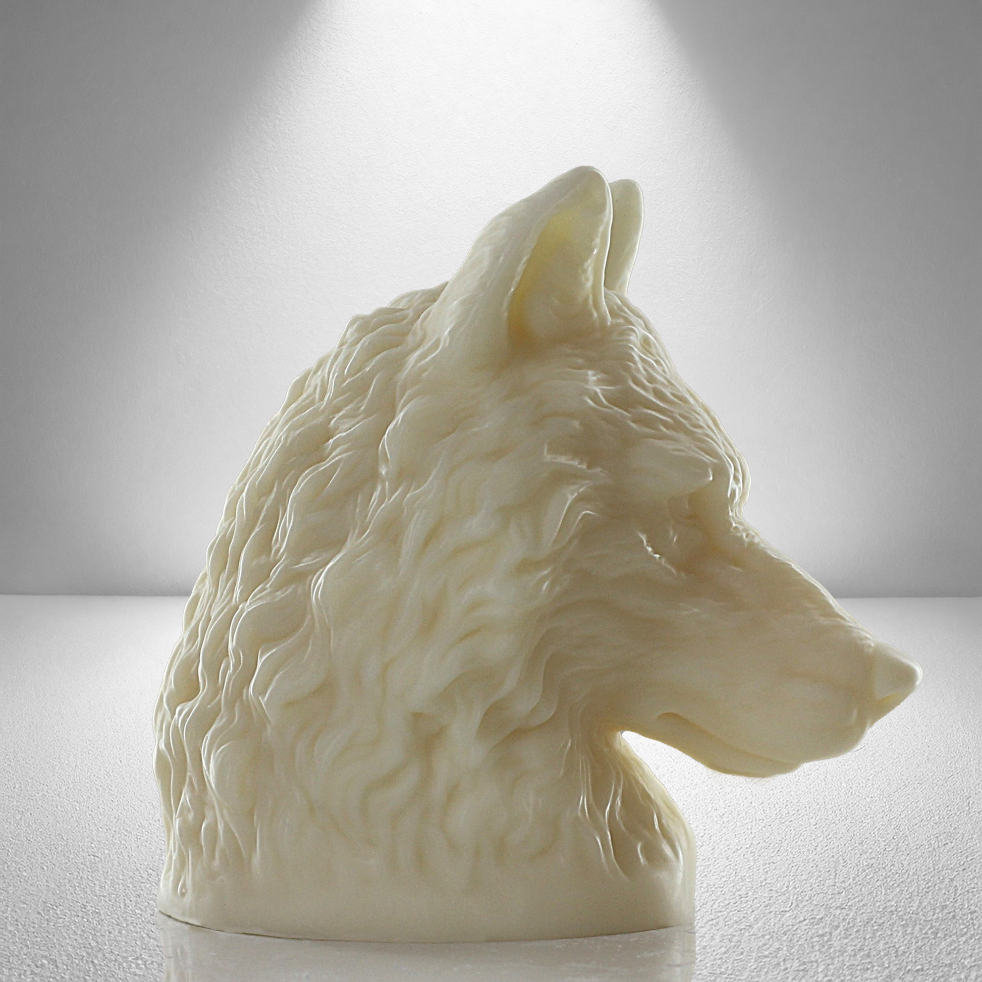 Large full 90 degree side view of soy unscented candle shaped like a wolf's head, featuring intricate fur details and a bold, majestic design.