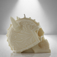 Full side view of a large soy unscented candle shaped like a Viking skull with intricate details and a horned helmet design. Bold and striking.